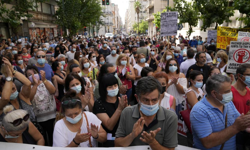 Healthcare workers take part in a rally in Athens on Thursday. &mdash; AP