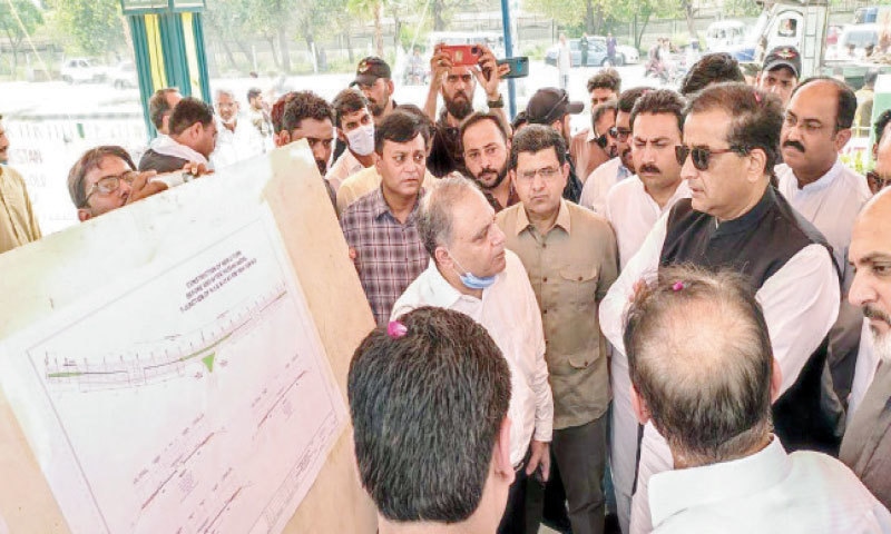 Special Assistant to the Prime Minister on Climate Change Malik Amin Aslam being briefed about the remodelling of Hassanabdal Chowk on Friday. &mdash; Dawn