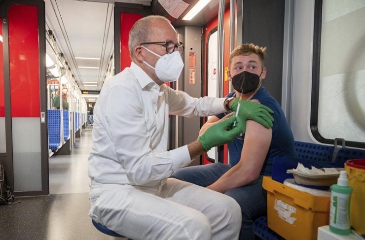 A medical officer vaccinates a man with the Johnson & Johnson vaccine in a special train of the public transport, in which vaccination against Covid-19 are offered, in Berlin, Germany, Aug. 30, 2021. &mdash; AP