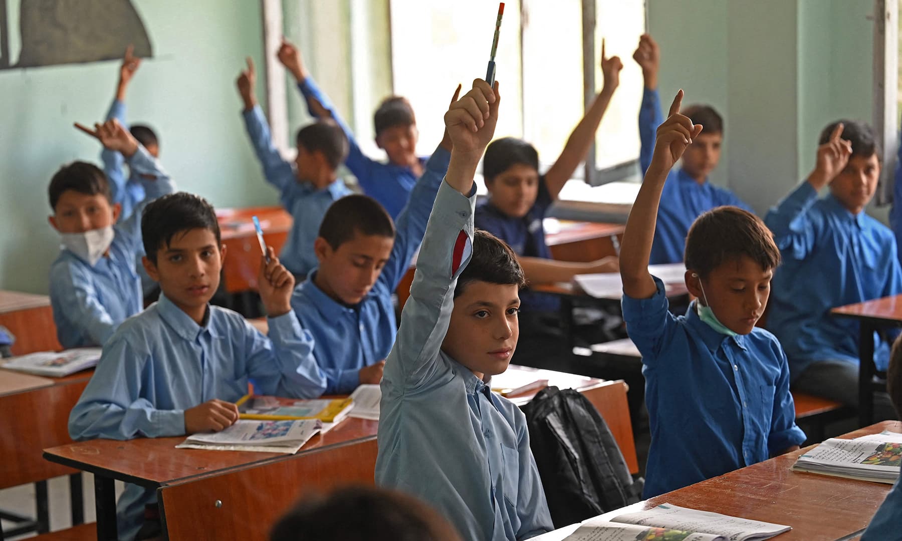 Students attend their class at a government middle school in Kabul on August 30. — AFP