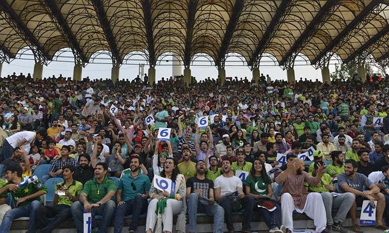 Cricket fans enjoy the International T20 cricket match between Zimbabwe's and Pakistani teams at the Gaddafi Cricket Stadium in Lahore on May 24, 2015. — AFP