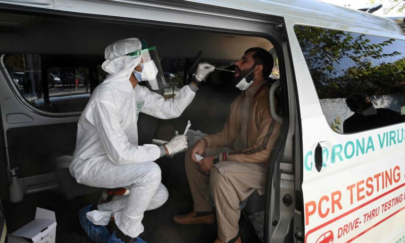 A health worker collects a sample for PCR testing. — AFP/File