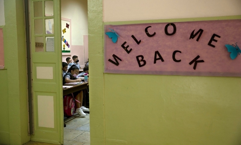 A girl takes notes in class on the first day of school at College des Freres in the Old City of Jerusalem on Sept 1. — AP