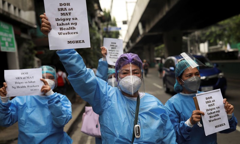 Healthcare workers hold a protest outside the Philippines' Department of Health, demanding better wages and benefits in Manila. — Reuters