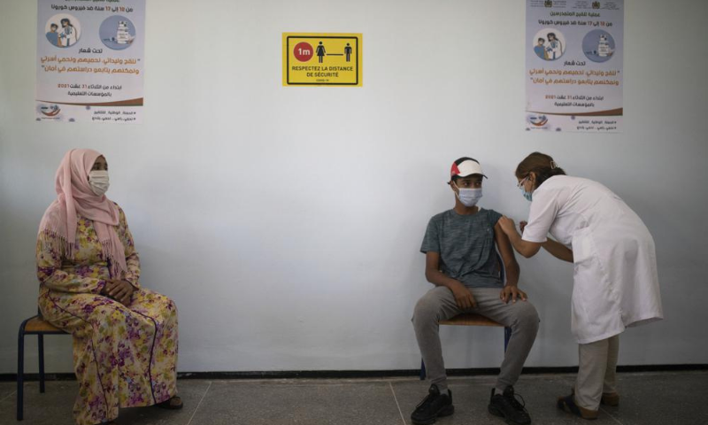 A mother accompanies her son to receive his Covid-19 vaccine as Morocco launches a campaign to vaccinate 12-17-year-olds before the start of the school year, in Rabat. — AP