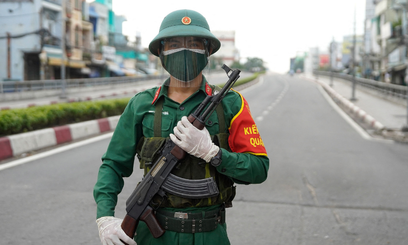 In this file photo, a Vietnamese military personnel stands guard on a deserted road in Ho Chi Minh City, after the government imposed a stricter lockdown to stop the spread of the Covid-19 coronavirus. &mdash; AFP
