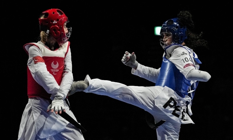 Peru's Leonor Espinoza Carranza (R) competes with Turkey's Meryem Cavdar during the final match of taekwondo women's 49kg (K44) of the Tokyo 2020 Paralympic Games at Makuhari Messe Hall on September 2. &mdash; AFP