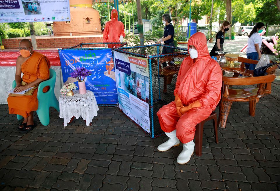 A Buddhist monk wears a PPE suit in Bangkok, Thailand on August 30. &mdash; Reuters