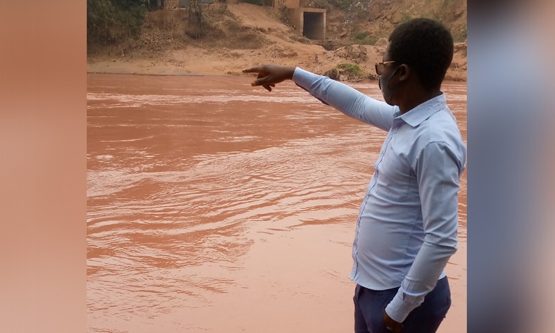 A man gestures as he looks at the Tshikapa river after it turned red, in Tshikapa City, Kasai Province, Democratic Republic of Congo, in this handout picture taken August 11, 2021. — Reuters/File A man gestures as he looks at the Tshikapa river after it turned red, in Tshikapa City, Kasai Province, Democratic Republic of Congo, in this handout picture taken August 11, 2021. — Reuters/File