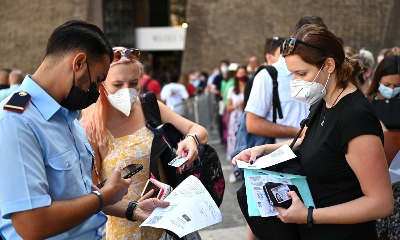 In this file photo taken on August 6, 2021 visitors show their UE digital Covid-19 certificate for scanning before entering the Vatican Museums. &mdash; AFP