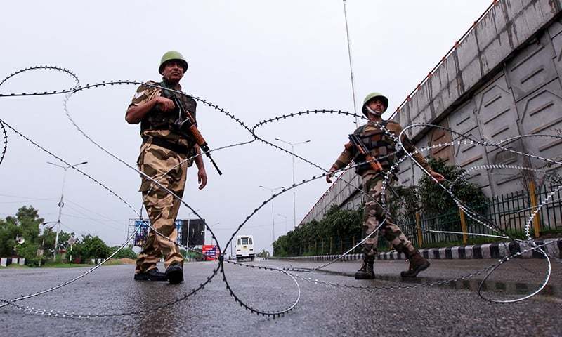 In this file photo, Indian security personnel stand guard at a roadblock in occupied Kashmir. — AFP/File