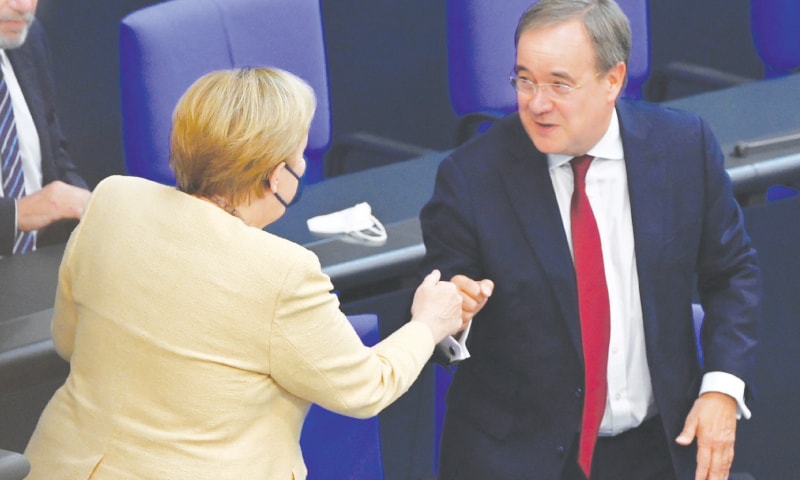 GERMAN Chancellor Angela Merkel bumps fists with Armin Laschet, tipped to succeed her as the Christian Democratic Union&rsquo;s chief next month, during a session of parliament&rsquo;s lower house.&mdash;AFP