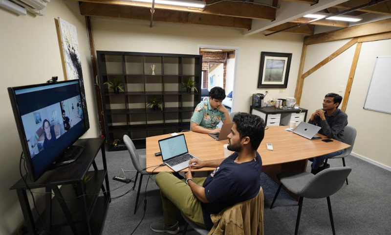 RunX CEO Ankur Dahiya, centre, takes part in a video meeting with employees JD Palomino, top left, and Nitin Aggarwal, right, at a rented office in San Francisco. &mdash; AP/File