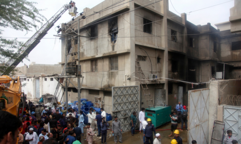 In this file photo, rescue workers search for bodies at the site of a burnt chemical factory, in Karachi, on Aug 27. — AP/File