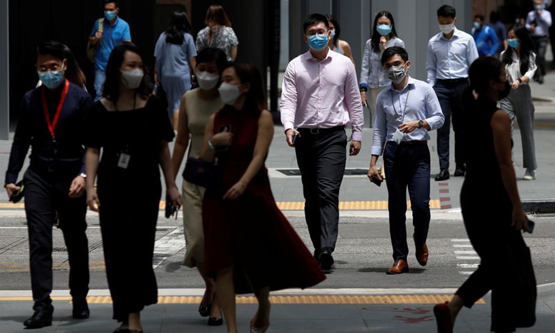Office workers spend their lunch breaks at the central business district during the Covid-19 outbreak in Singapore. &mdash; Reuters