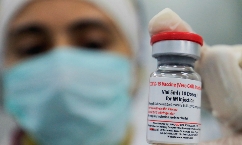 Dr Mai Osama (IPC Manager) holds a vial of China's Sinovac Covid-19 vaccine in the visual inspection unit of the Holding Company for Biological Products and Vaccines “Vacsera” in Cairo, Egypt. — Reuters/File