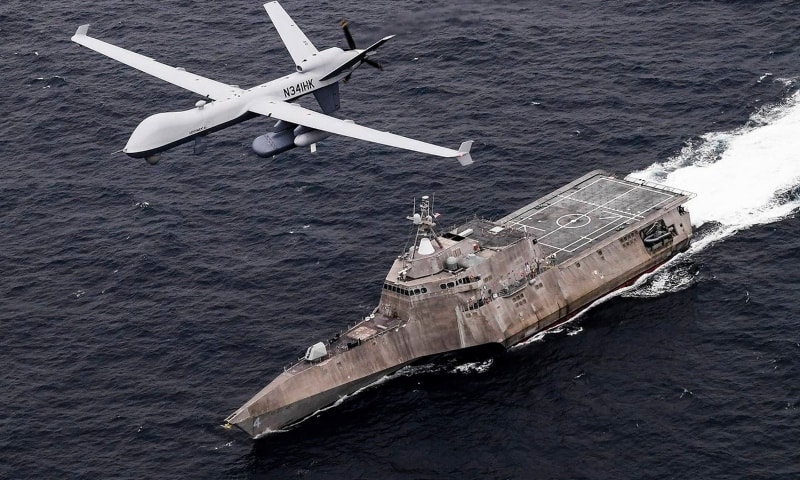 An MQ-9 Sea Guardian unmanned maritime surveillance drone flies over the littoral combat ship Coronado during a drill in the Pacific Ocean April 21. — AP