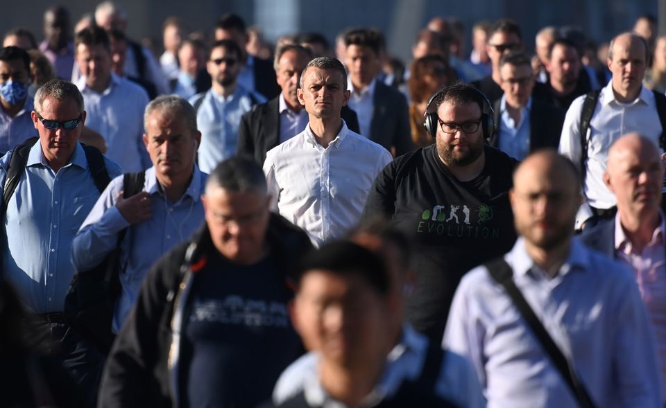 Workers walk towards the City of London financial district as they cross London Bridge during the morning rush hour in London, Britain on September 8. — Reuters
