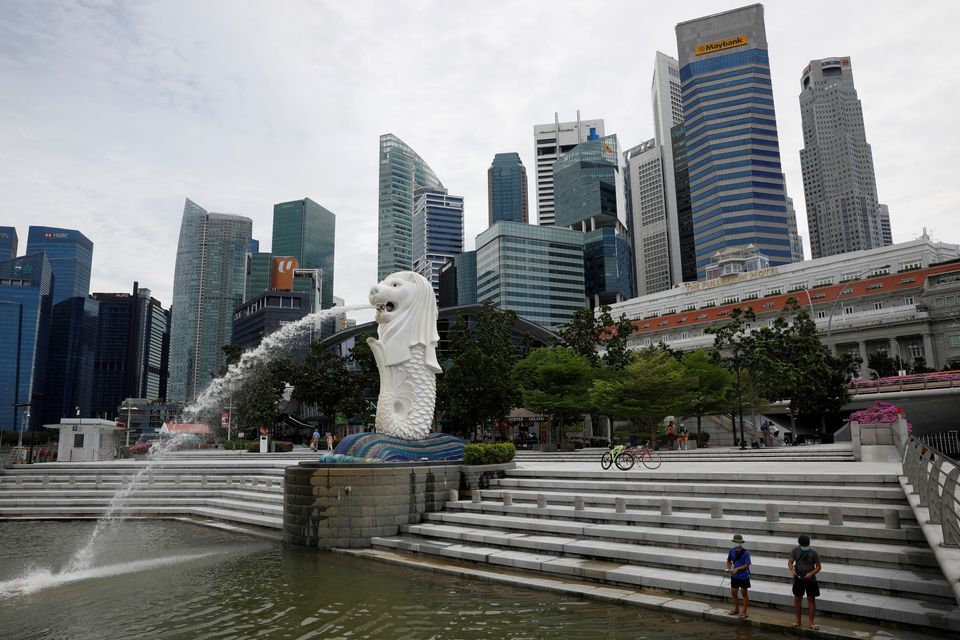 Youth fish at a largely empty Merlion Park in Singapore on August 31. &mdash; Reuters