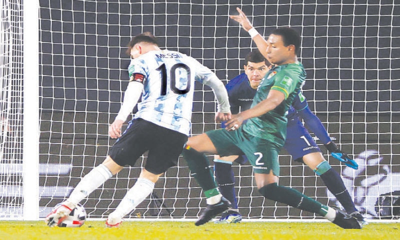 BUENOS AIRES: Argentina&rsquo;s Lionel Messi (L) shoots to score during the World Cup qualifier against Bolivia at the Monumental Stadium.&mdash;AFP