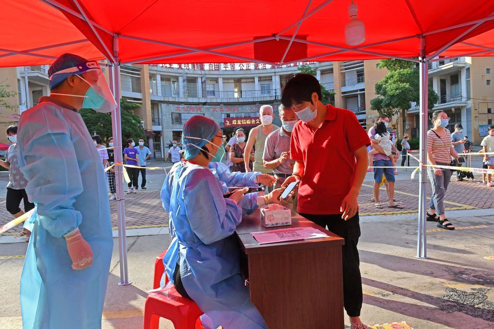 Residents register to take nucleic acid tests at a testing site in Quanzhou, following new cases of the coronavirus in Fujian province, China on September 13. — Reuters
