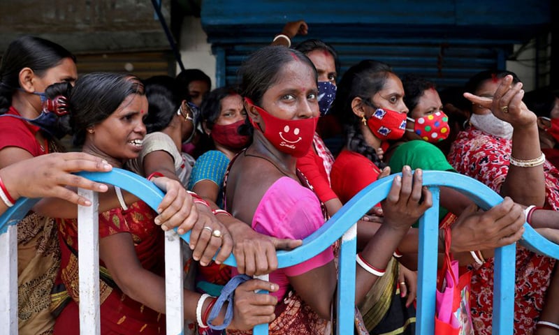 In this file photo, women wait to receive a dose of Covishield vaccine outside a vaccination centre in Kolkata, India. — Reuters/File