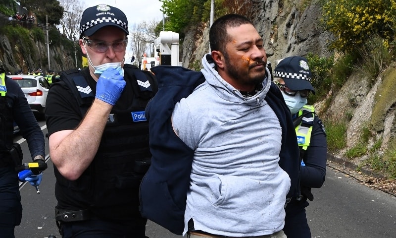 Police arrest a protester during an anti-lockdown rally in Melbourne on September 18. — AFP