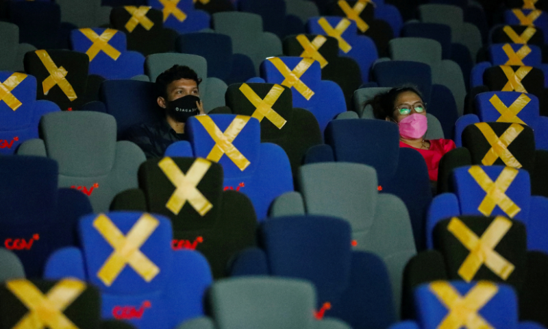 Visitors wearing protective masks watch a movie at a cinema as it is reopened after the easing of restrictions amid the coronavirus pandemic in Jakarta, Indonesia. — Reuters