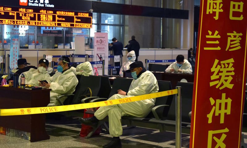 In this file photo, police officers in protective suits are seen at an airport in Harbin, China. &mdash; Reuters/File