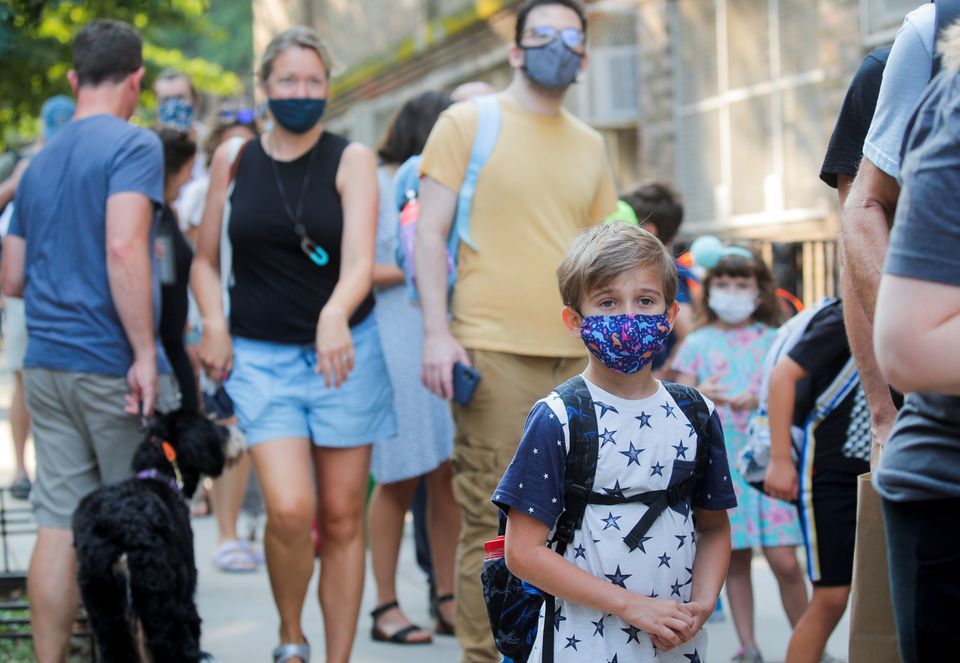 A child wears a face mask on the first day of New York City schools reopening in Brooklyn, New York, US, on September 13. &mdash; Reuters