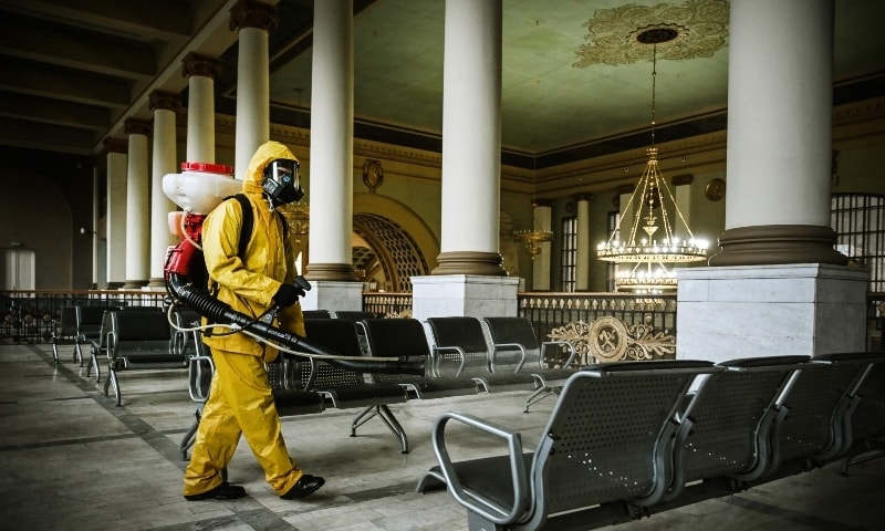A serviceman of Russia's Emergencies Ministry, wearing protective gear, disinfects Kievsky railway terminal amid the Covid-19 pandemic in Moscow. — AFP