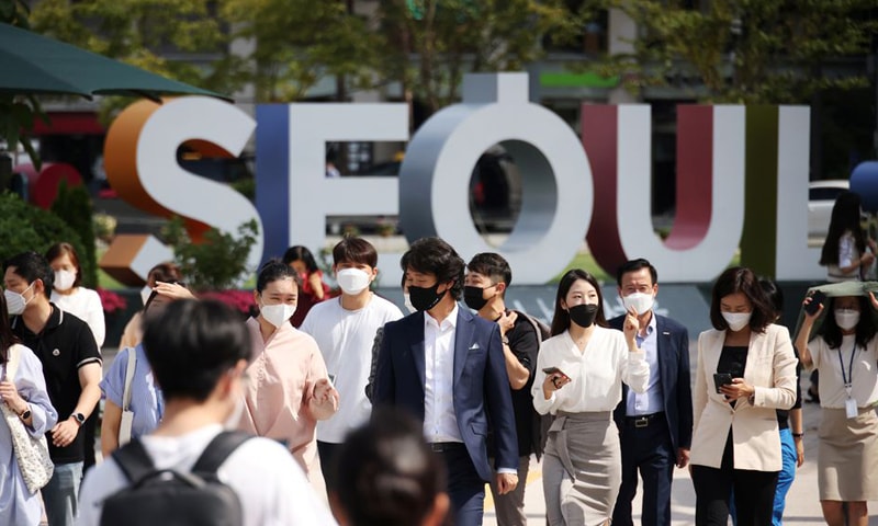 In this file photo, commuters wearing masks to avoid contracting Covid-19 walk on a zebra crossing in Seoul, South Korea. — Reuters/File