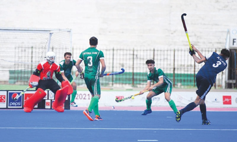 KARACHI: A Navy player takes a shot on goal against National Bank during their pool match of the CNS All-Pakistan Hockey Tournament at the Abdul Sattar Edhi Stadium on Saturday.--INP KARACHI: A Navy player takes a shot on goal against National Bank during their pool match of the CNS All-Pakistan Hockey Tournament at the Abdul Sattar Edhi Stadium on Saturday.--INP