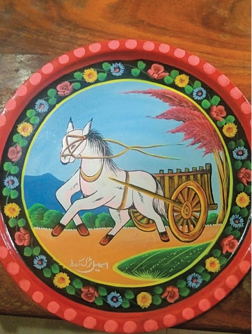 A decorative plate signed by the artist