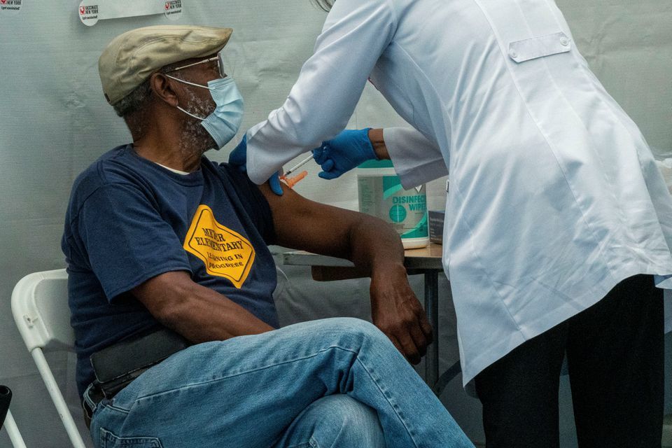 A person receives a dose of the Pfizer-BioNTech vaccine for the coronavirus in New York City on September 27. &mdash; Reuters