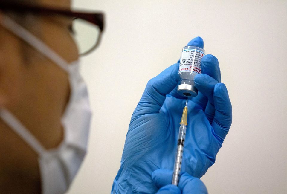 Medical staff prepare Moderna vaccine to be administered at a newly-opened mass vaccination centre in Tokyo, Japan, May 24. — Reuters