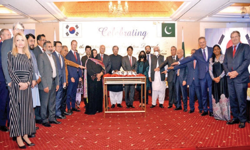 Education Minister Shafqat Mahmood, Senator Mushahid Hussain Syed, Korean Ambassador Suh Sangpyo and others pose for a photograph during the Foundation Day and the Armed Forces Day celebrations in Islamabad. — INP Education Minister Shafqat Mahmood, Senator Mushahid Hussain Syed, Korean Ambassador Suh Sangpyo and others pose for a photograph during the Foundation Day and the Armed Forces Day celebrations in Islamabad. — INP