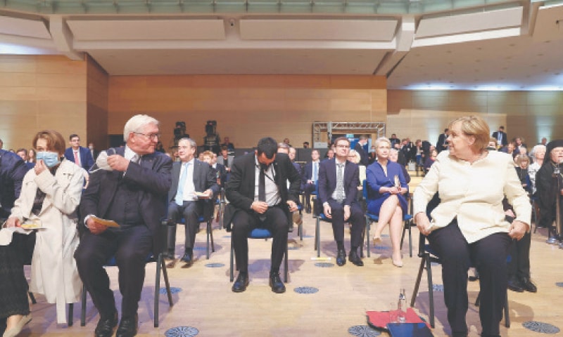 GERMAN Chancellor Angela Merkel speaks to President Frank-Walter Steinmeier during an event in Halle to mark the reunification of Germany on Oct 3. — AFP GERMAN Chancellor Angela Merkel speaks to President Frank-Walter Steinmeier during an event in Halle to mark the reunification of Germany on Oct 3. — AFP
