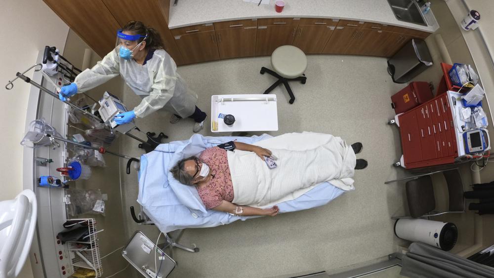 A nurse cares for a patient as she receives an antibody infusion while lying on a bed in a trauma room at the Upper Tanana Health Centre in Tok, Alaska, US on Sept 22. — AP