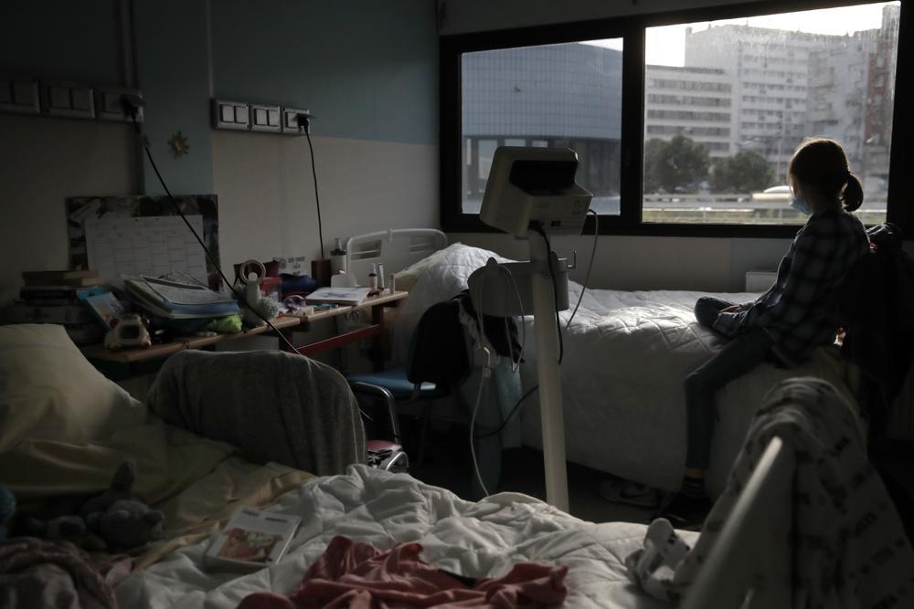 In this March 2, 2021 file photo, a young girl looks out the window of her room in the pediatric unit of the Robert Debre hospital, in Paris, France. — AP/File