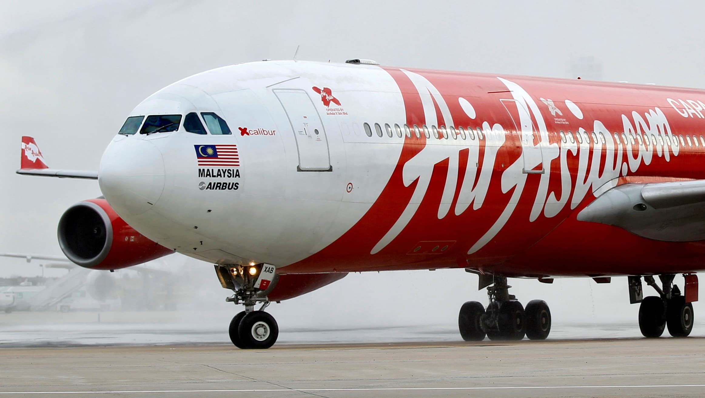 An AirAsia X Airbus A340 passenger jet arrives on its inaugural flight from Kuala Lumpur to Paris Orly Airport February 14, 2011. — Reuters