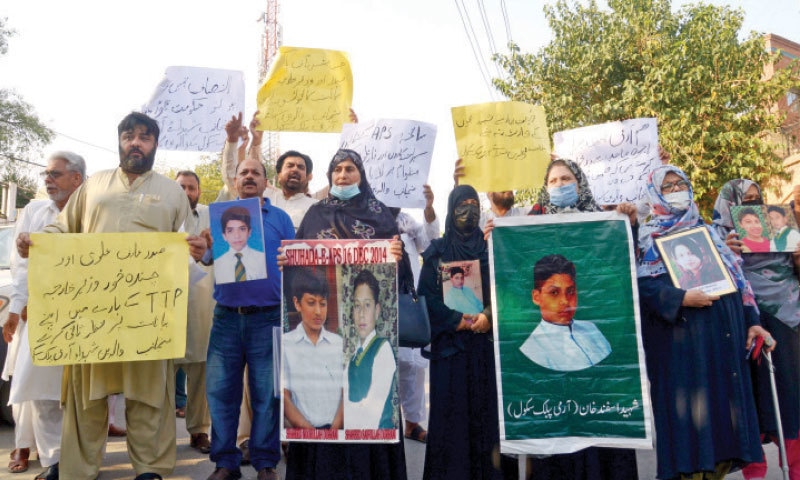 Parents holding pictures of their children, who were martyred in the Army Public School attack, protest outside the Peshawar Press Club on Thursday. — White Star