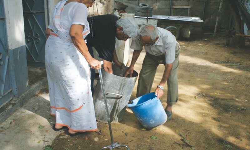 Fatima Aunty watches Futehally mending a pot hole