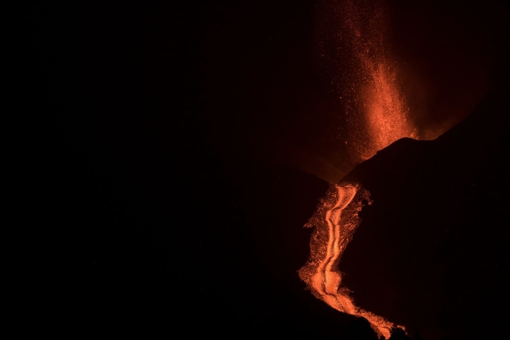 Lava flows from the Cumbre Vieja volcano,as seen from Los Llanos de Aridane in the Canary Island of La Palma at night on October 9. — AFP Lava flows from the Cumbre Vieja volcano,as seen from Los Llanos de Aridane in the Canary Island of La Palma at night on October 9. — AFP