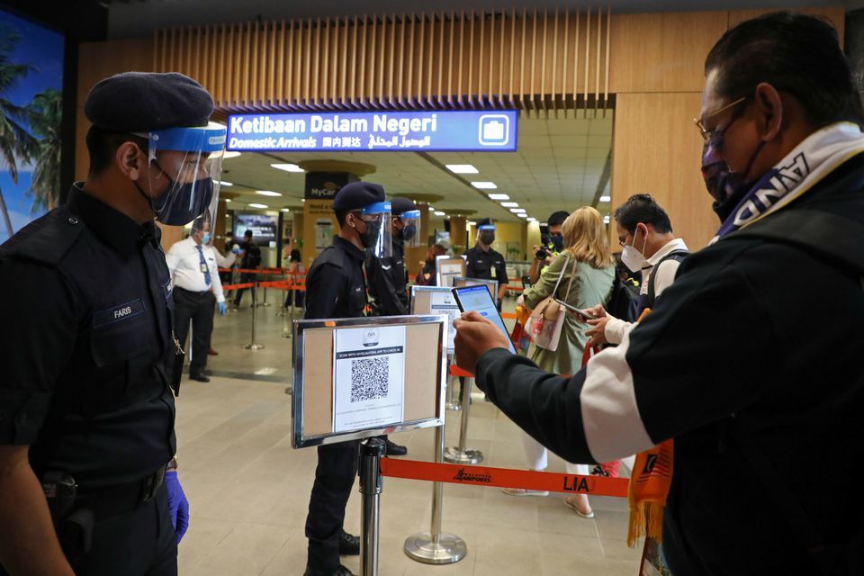 A tourist scans a QR code to check-in upon arriving at the airport as Langkawi reopens to domestic tourists, amid the coronavirus pandemic in Malaysia, September 16. — Reuters