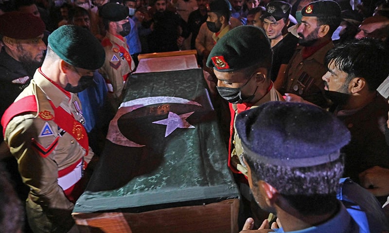 Soldiers prepare to place the flag-draped coffin of Dr Abdul Qadeer Khan during his funeral outside the Faisal Mosque in Islamabad on October 10. — AFP