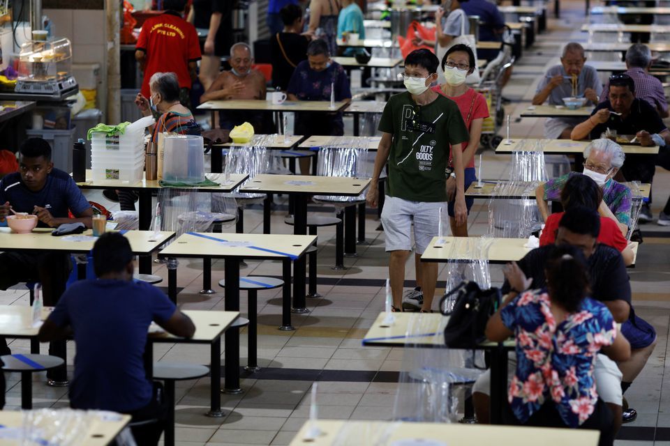 People eat at a hawker centre during the coronavirus outbreak in Singapore, September 21. &mdash; Reuters