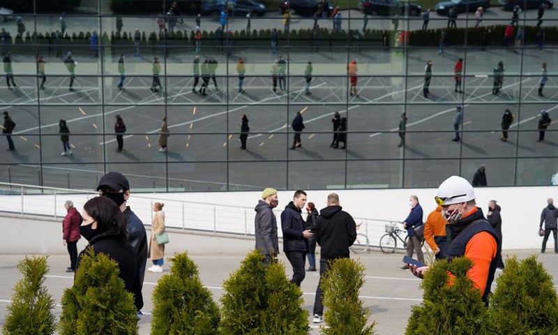 In this file photo, people queue up outside a mass vaccination centre as Latvia opens walk-in Covid-19 vaccination scheme in Riga, Latvia. — Reuters/File