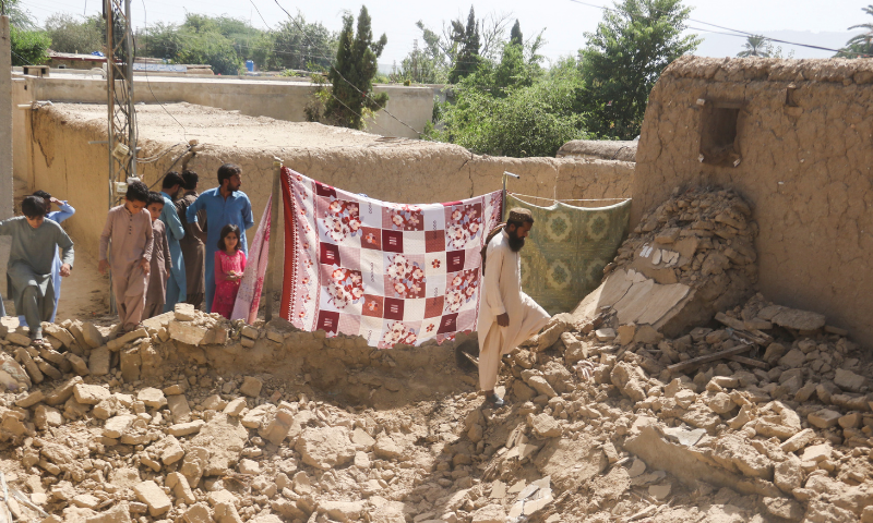 Residents gather near a damaged house following an earthquake in Harnai, Balochistan. — Reuters/File