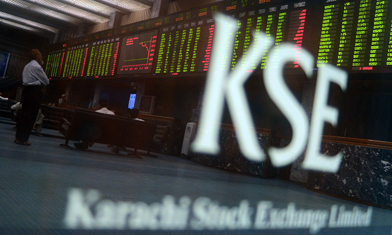 Pakistani stockbrokers watch the latest share prices on a digital board during a trading session at the Karachi Stock Exchange (KSE) in Karachi on May 28, 2013. — AFP